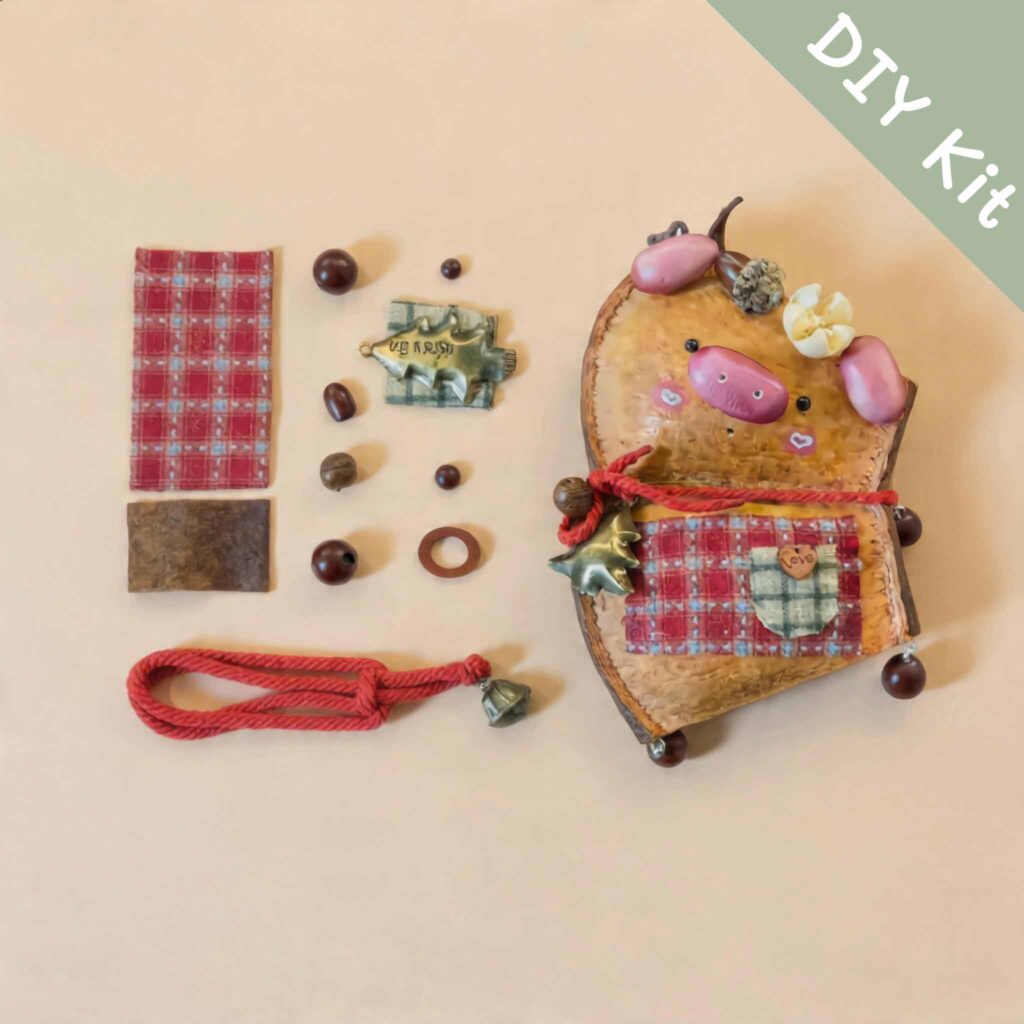 DIY kit materials for Handmade Cozy Piglet Decor arranged beside the finished piglet design on a neutral background
