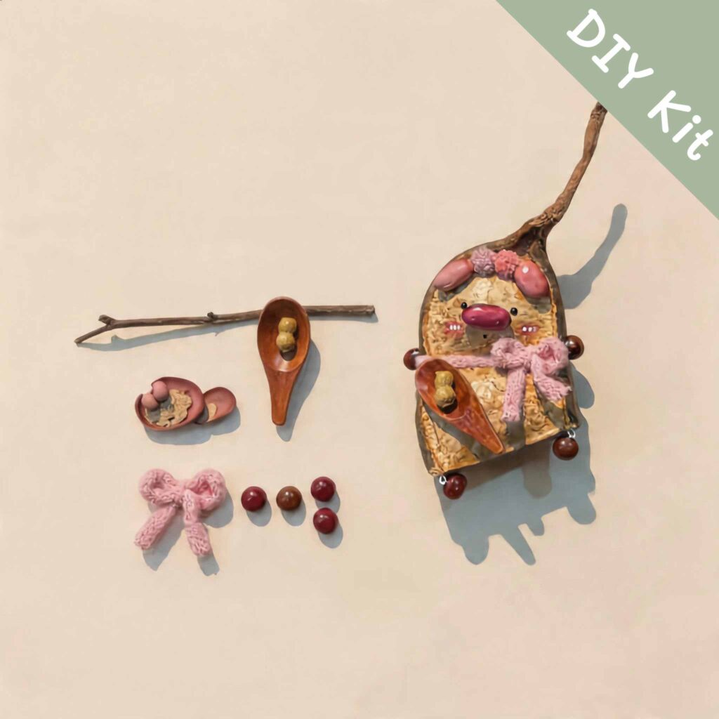 DIY kit materials for Handmade Whimsical Piglet Bell Decor arranged beside the finished design on a neutral background