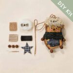 DIY kit materials for Pod Doll Midnight Scarf Poodle arranged beside the finished design on a neutral background
