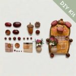 DIY kit materials for Double-Sided Pig Pod Doll Bloom Vase Edition arranged beside the finished design on a neutral background