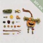 DIY kit materials for Open-Mouth Pod Doll Mossy Tassel Gremlin arranged on a neutral background beside the finished design