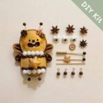 Star Bee Fairy pod doll DIY kit with natural seed pod pieces, pom-poms, star charm, antenna parts, and handmade accessories