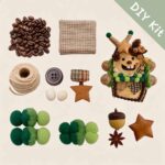 Flat lay of a DIY kit featuring a reindeer-themed open-mouth pod doll base, coffee bean accents, green pom details, and rustic woodland accessories