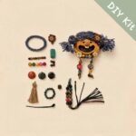 Flat lay of a DIY kit featuring a blue pigtail open-mouth pod doll charm with colorful beads and handmade accessories