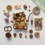 Flat lay of a DIY kit for a handmade open-mouth woodland fishing pod doll with natural materials and tiny accessories