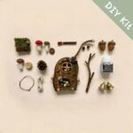 Flat lay of a DIY kit for a handmade open-mouth festive pod doll with red pouch accessories and natural materials