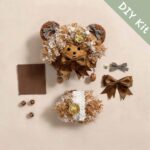 Pod Doll Mocha Ribbon Bear DIY Kit flat lay with bear head, curly mocha hair, satin bow, gingham bows, and craft materials