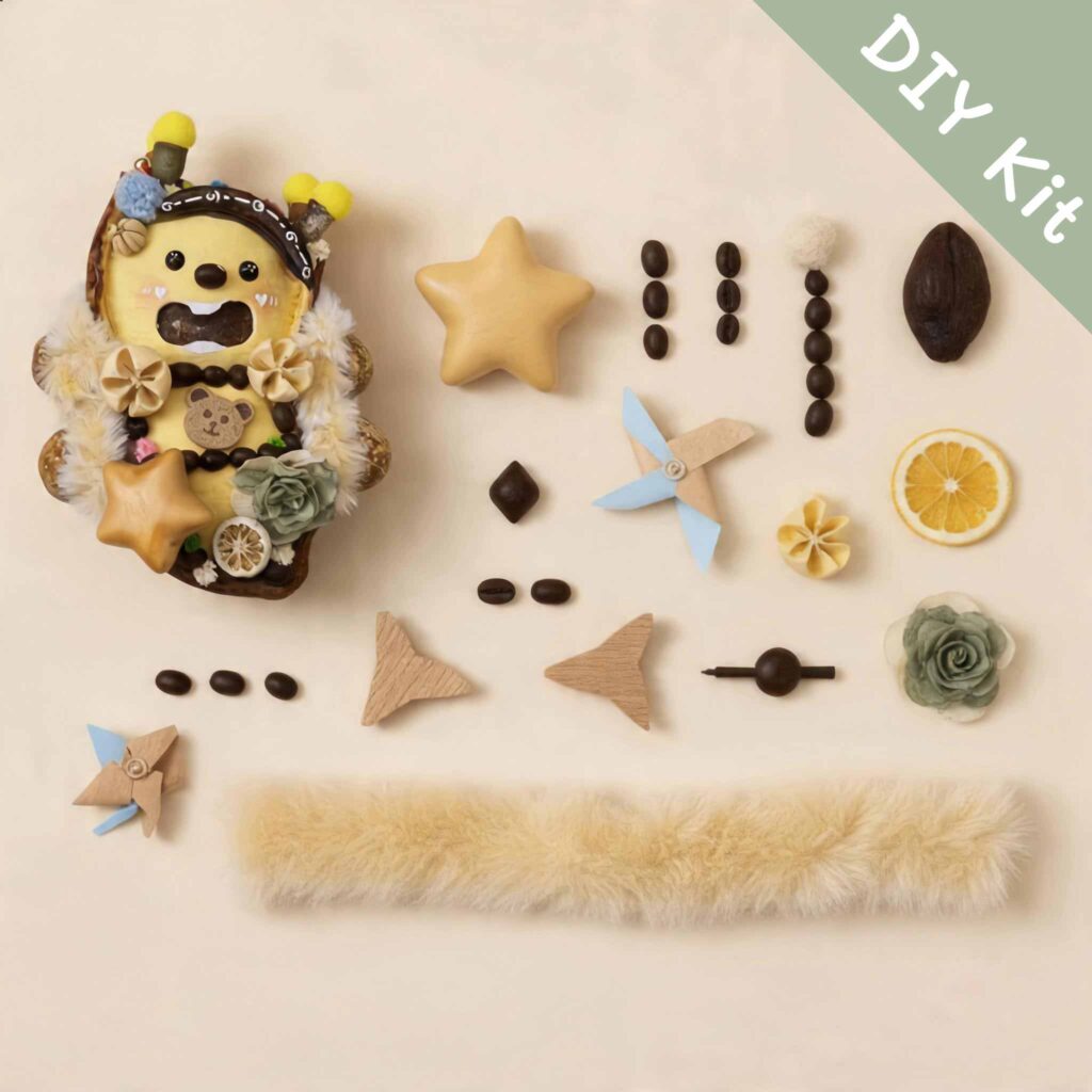 Open-mouth pod doll DIY kit flat lay with star piece, floral parts, fluffy trim, beads, and handmade components