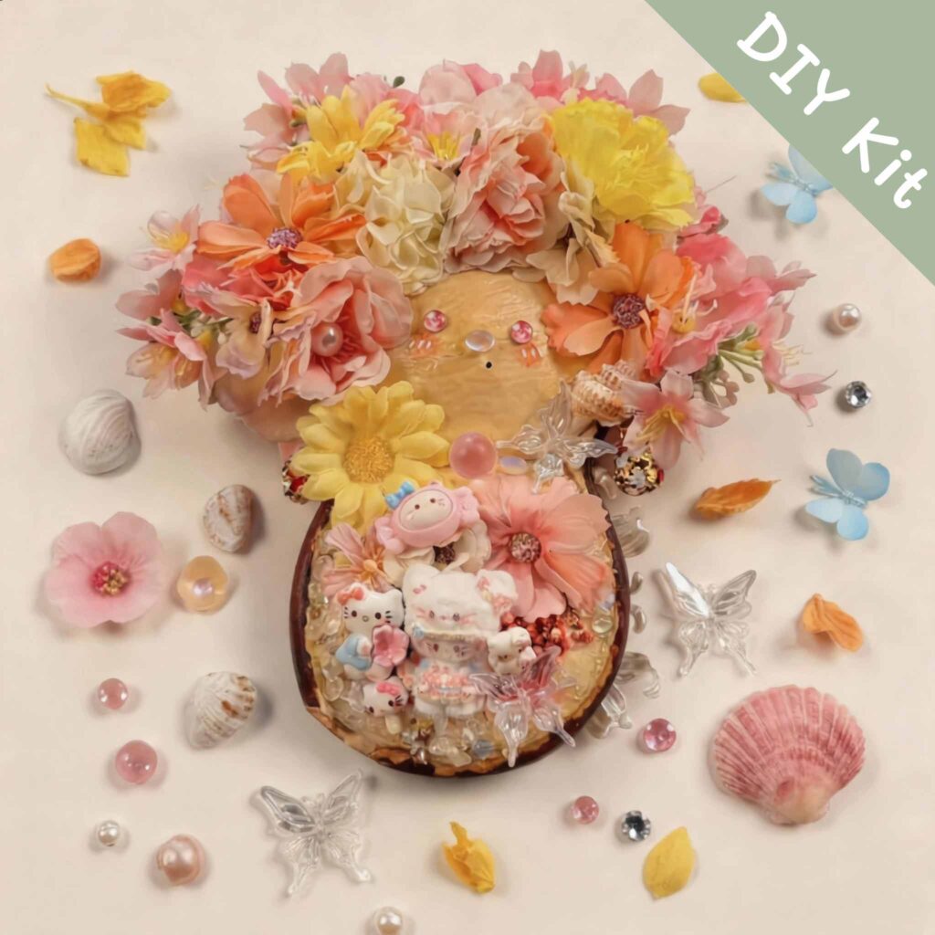 Floral pod doll DIY kit flat lay with pink and yellow flowers, pearl accents, butterfly embellishments, and pastel decorative parts