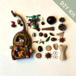 Flat lay of a DIY kit for a handmade woodland pod house ornament with squirrel, acorns, and forest-themed materials