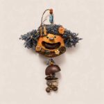 Open-Mouth Pod Doll Charm Midnight Chime with deep blue yarn pigtails and dangling chime-inspired drop on a neutral background