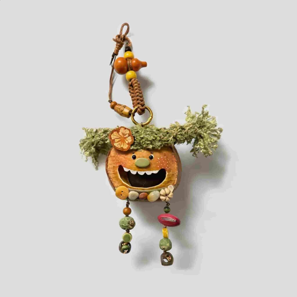 Open-Mouth Pod Doll Mossy Tassel Gremlin with mossy green tassel pigtails and dangling woodland strands on a neutral background
