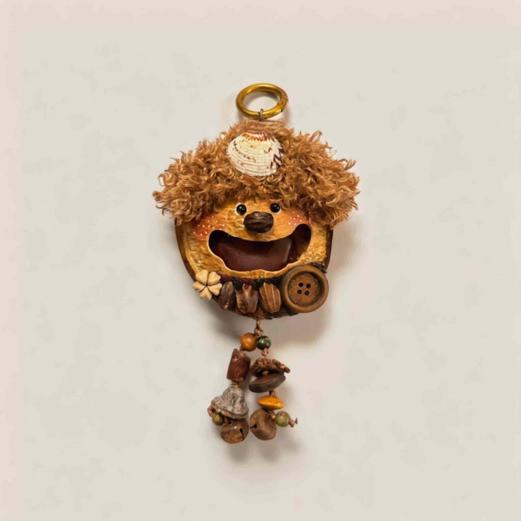 Front view of Walnut Shell Sprite handmade pod doll charm with joyful wide smile and soft curly woodland styling