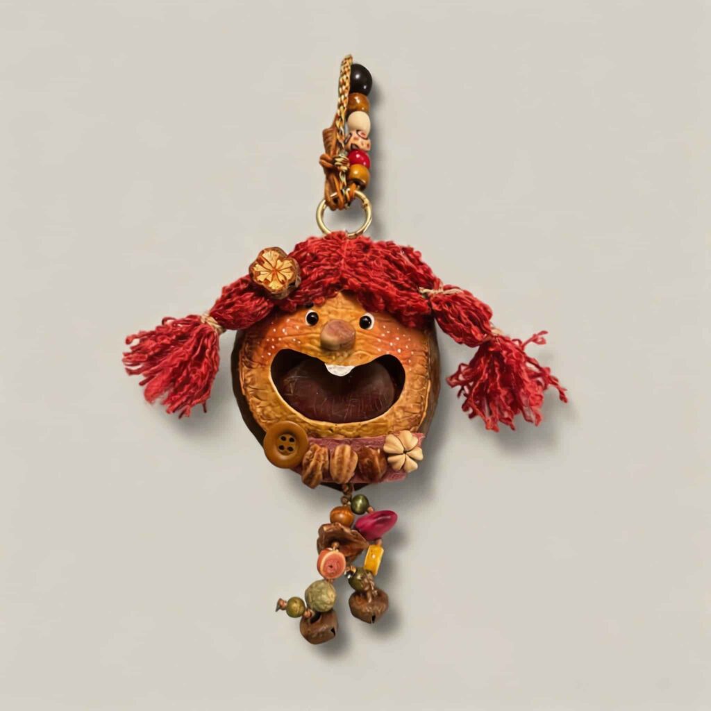 Open-Mouth Pod Doll Berry Tassel Sprite with vivid berry-red tassel pigtails and dangling woodland-inspired charm cluster on a neutral background
