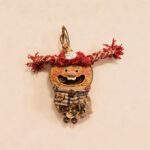 Front view of Scarlet Twiglet handmade pod doll charm with bright red pigtails, open-mouth smile, and tiny hanging bell accents