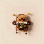 Open-Mouth Pod Doll Sunny Bloom Bug with yellow-tipped antennae, joyful wide smile, and tiny flower basket on a neutral background