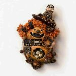 Open-Mouth Pod Doll Steampunk Skull Bloom with fiery orange textured hair, steampunk hat, skull accent, and floral window scene on a neutral background