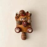 Front view of Autumn Acorn Kitty handmade cat pod doll with soft pumpkin centerpiece and swinging tail design