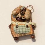 Open-Mouth Pod Doll Plaid Pocket Puppy with floppy ears, plaid pocket detail, and woodland accents on a neutral background