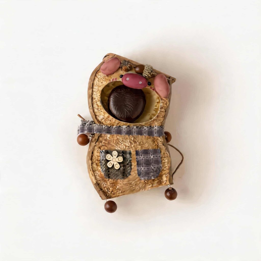 Chestnut Pocket Pig Pod Doll with pink piggy details, patchwork-style pockets, and chestnut centerpiece on a neutral background