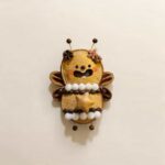 Handmade open-mouth Star Bee Fairy pod doll with tiny wings, antennae, white pom-pom details, and a wooden star centerpiece
