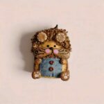 Handheld Curly Whisker Hamster pod doll showing curly textured hair, rounded ears, whisker face details, and cozy woodland handmade styling