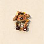 Front view of an open-mouth bunny baker pod doll with floral details, plaid apron, and wooden spoon