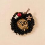 Handmade Midnight Scholar pod doll with black curly hair, round glasses, and warm storybook character details