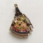 Rustic witch-inspired handmade pod doll isolated on light background