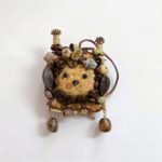 Front view of finished Coffee Grove Sprite pod doll on a plain background with coffee bean trim and natural rustic embellishments.