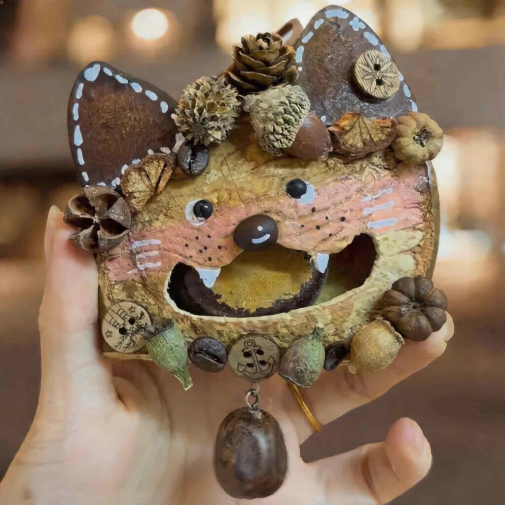 Handmade Open-Mouth Pod Doll Woodland Fox held in hand, showing forest-inspired details, textured materials, and dangling charm