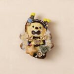 Front view of open-mouth pod doll with fluffy trim, star accent, and bear charm