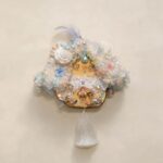 Front view of floral pod doll with dreamy pastel flower details, pearl accents, and white tassel