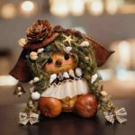 Tidebell Shell Girl Pod Doll finished doll lifestyle view with shell accents bell detail and cream dress