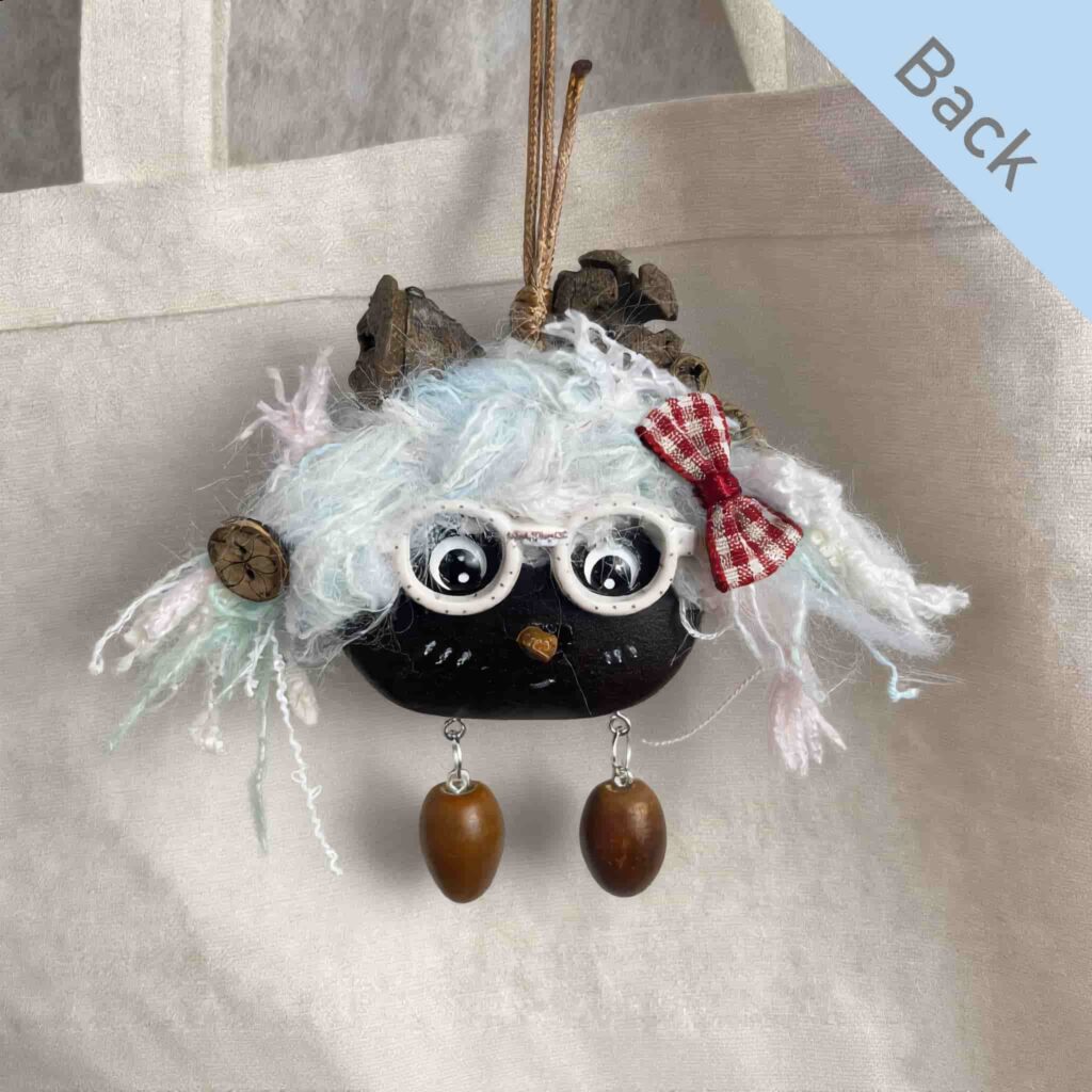Double-Sided Pod Doll – Frostmint Peace Bean back view with white glasses and red bow displayed on a canvas tote bag
