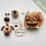 DIY kit materials for Open-Mouth Pod Doll Charm Hazel Giggle arranged on a neutral background beside the finished design