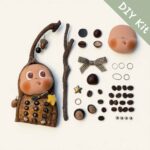 Acorn Phone Pod Doll DIY kit flat lay with prepared materials branch parts face piece and decorative components