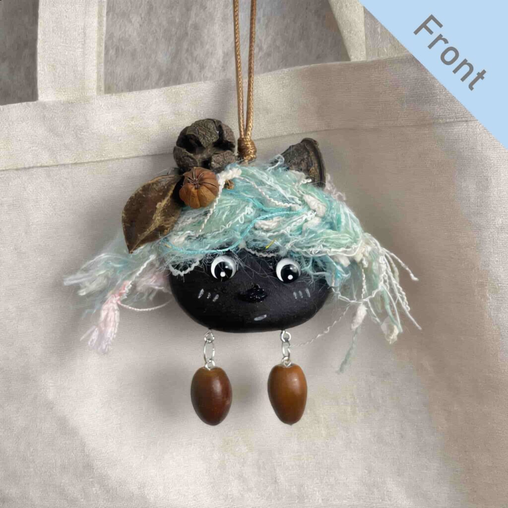 Double-Sided Pod Doll – Frostmint Peace Bean front view displayed on a canvas tote bag