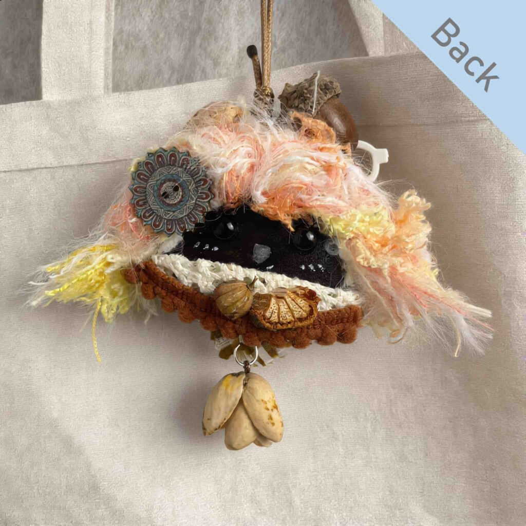 Double-Sided Pod Doll – Lemon Soda Peace Bean back view with soft peach and cream yarn hair on a canvas tote bag