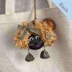 Double-Sided Pod Doll Cocoa Curl Pixie back view hanging on a canvas bag