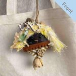 Double-Sided Pod Doll – Lemon Soda Peace Bean front view hanging on a canvas tote bag