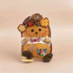 Back view of Tartan Bear Cub pod doll with tartan bow, handmade tag, and rustic woodland details