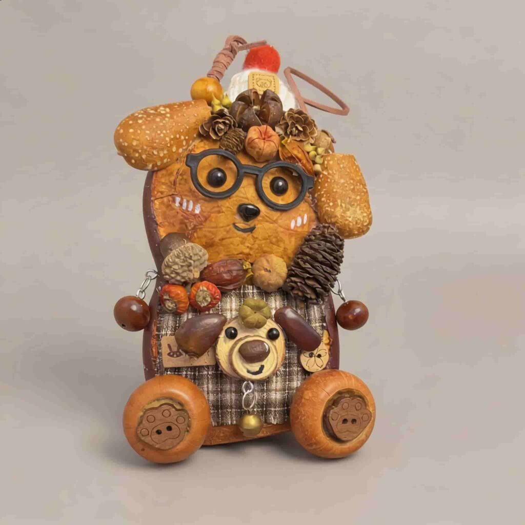 Close front view of Forest Scholar Wagon pod doll with autumn botanical embellishments, wagon wheels, and bear accent