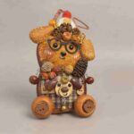 Close front view of Forest Scholar Wagon pod doll with autumn botanical embellishments, wagon wheels, and bear accent