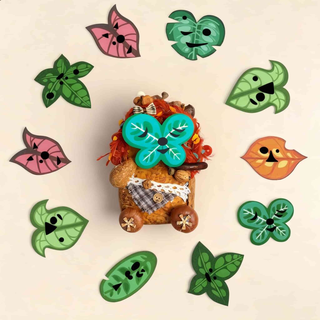Double-sided pod doll displayed with multiple interchangeable magnetic leaf faces in different shapes and colors, including green, pink, and orange designs.