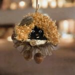 Handmade double-sided peace bean ornament with curly cocoa hair and brown ruffle