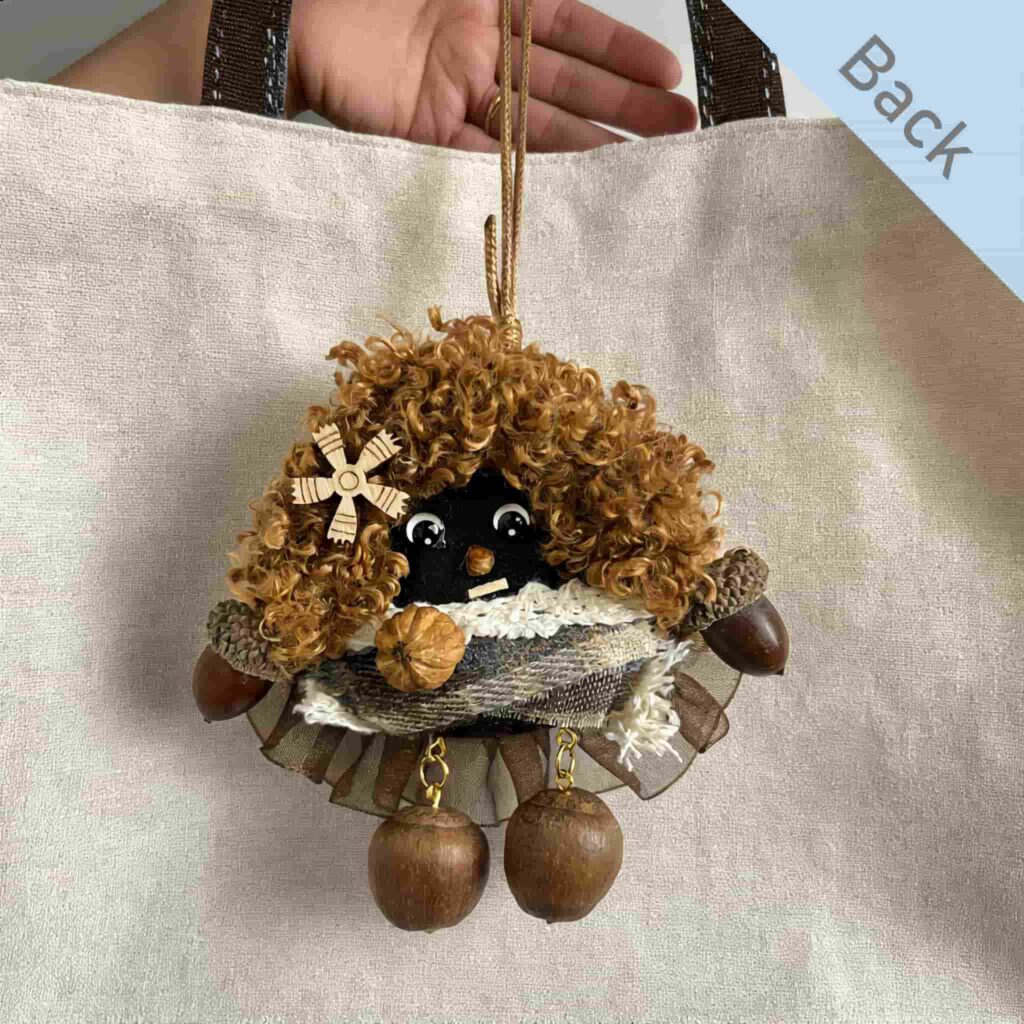 Double-Sided Peace Bean Bag Charm back view shown against a cream tote bag