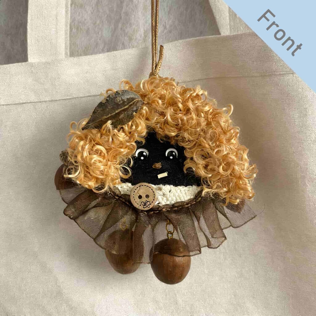 Double-Sided Peace Bean Bag Charm front view hanging on a cream fabric tote bag