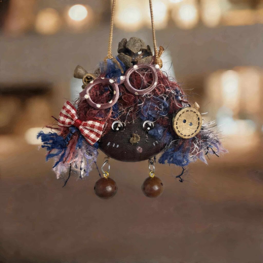 Handmade double-sided peace bean doll with berry-toned yarn hair and tiny glasses