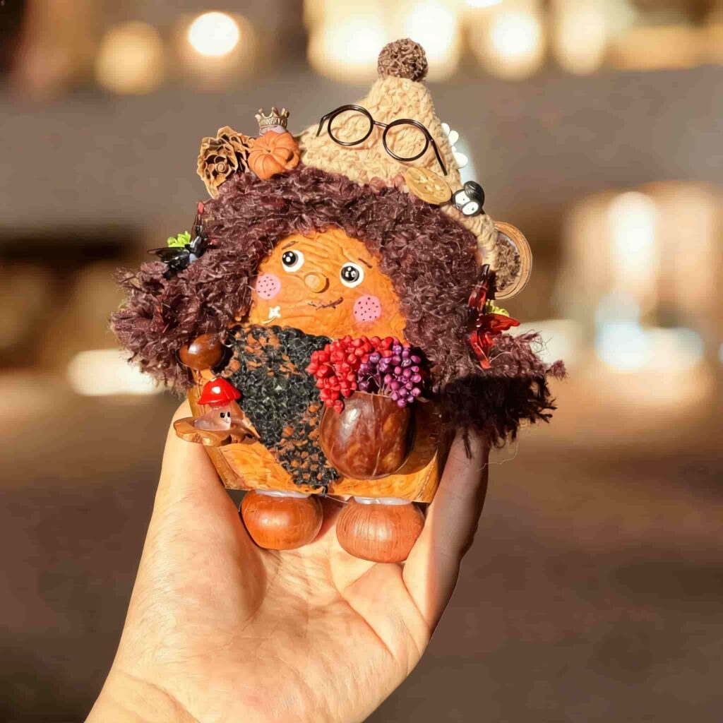 Autumn Witch Pod Doll Bramble Scholar finished doll held in hand showing size and handmade autumn details